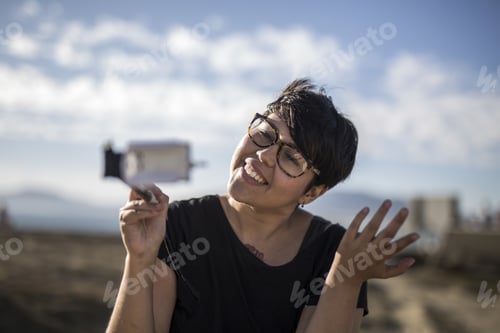 Preview: Shallow focus shot of a young female vlogging outdoors