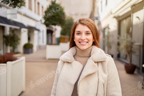 Preview: Portrait of a stylish woman smiling while standing outdoors.