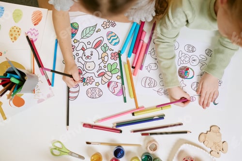 Preview: Two Children Coloring Easter Egg Drawings Using Colored Markers