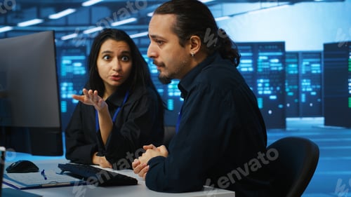 Preview: IT technicians in server farm brainstorming ways to repair equipment