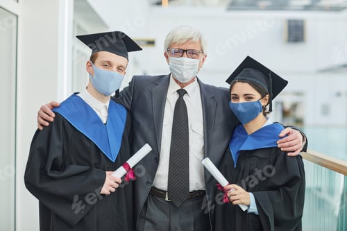 Preview: Students posing with professor at graduation