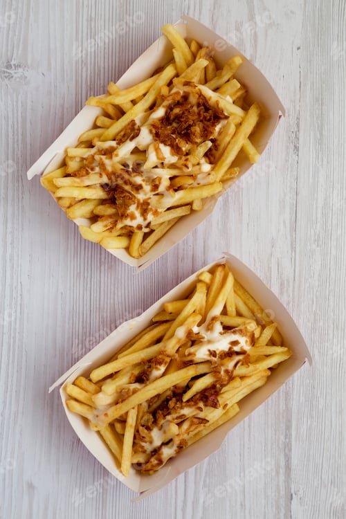 Preview: French fries with cheese sauce and fried onion in paper boxes
