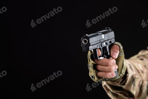 Preview: front view of young soldier in uniform aiming gun on black background warrior palestine
