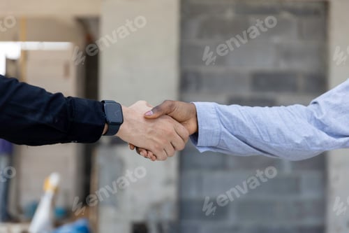 Preview: Engineering and foreman shaking hands on construction site and Agree. partnership and connection.