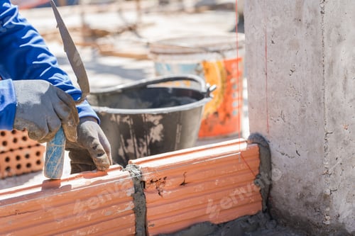 Preview: Hand worker masonry brickwork trowel construction site wall concrete background