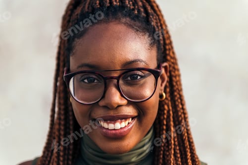 Preview: portrait of young black woman with glasses smiling