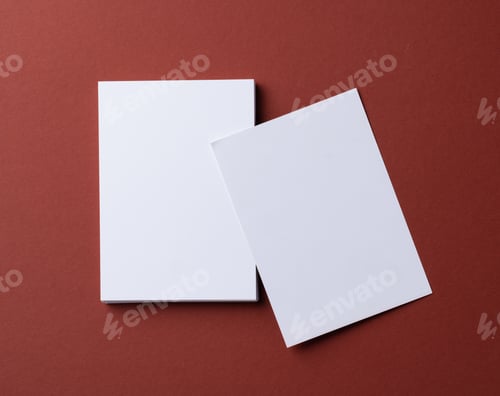 Preview: Blank white business cards on burgundy paper background