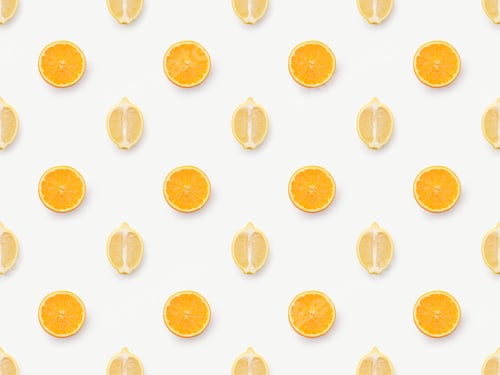 Preview: Top view of orange slices and lemons halves on white background