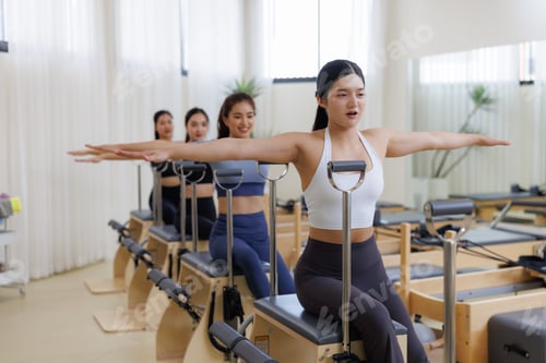 Preview: Women doing pilates chair exercise in group class