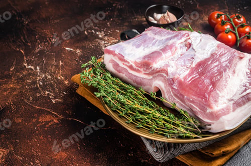 Vista previa: Farm fresh Pork belly, raw meat in a plate with spices. Dark background. Top view. Copy space