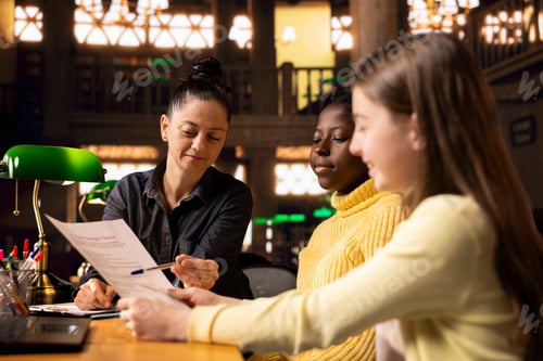Preview: Female tutor correcting the homework during private lessons with scholars
