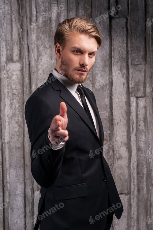 Preview: Confident in his style. Handsome young man in formalwear pointing you