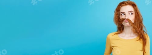 Preview: Headshot Portrait of happy ginger red hair girl with freckles smiling looking at camera. Pastel