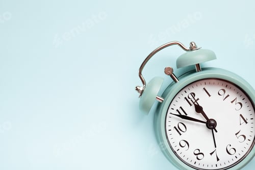 Preview: Retro style alarm clock over the blue background