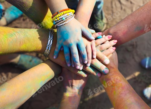 Preview: Friends putting their hands together in a sign of unity and teamwork. Friendship concept