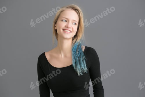 Preview: Woman color hair with blue colored hairstyle ower gray wall