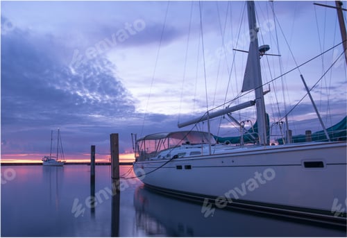Preview: Sailing boat on the calm sea under the breathtaking sunrise captured in Lexington Marina, Michigan