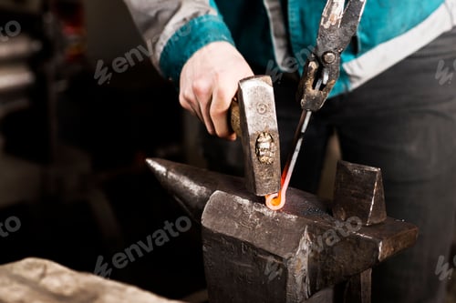 Preview: Closeup shot of a blacksmith hammering a hinge on an anvil