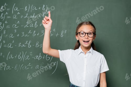 Preview: excited schoolgirl in eyeglasses showing idea gesture near chalkboard with equations
