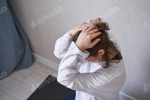 Preview: Young caucasian female in yoga retreat posing indoors with calm focus and relaxed expression