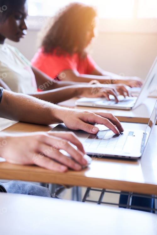 Preview: Vertical Close-up of the laptop in the classroom. A multi-ethnic group of high school students study