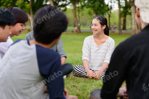 Preview: Happy young group of friends having fun together at the park