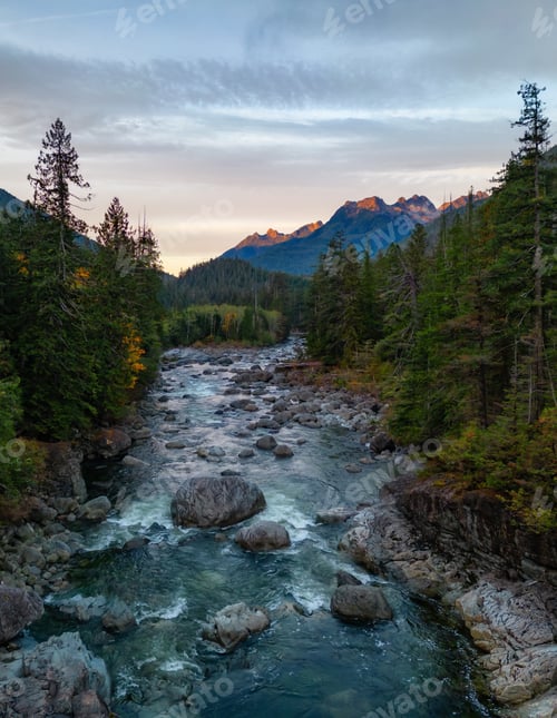 Preview: Rocks, Trees and River with Mountains in Background. Colorful Sunrise.