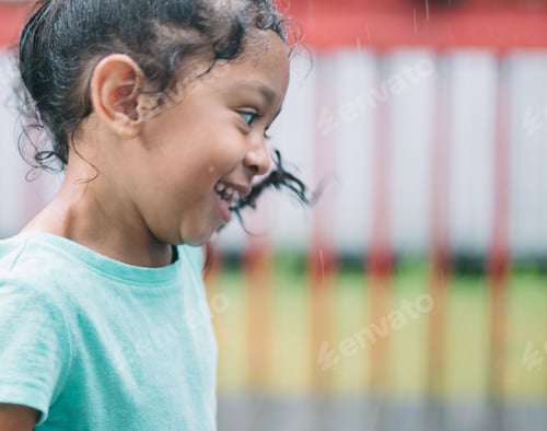 Preview: A little girl dancing in the rain