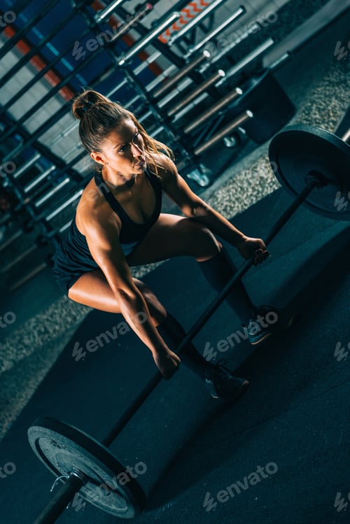 Preview: Cross training. Female athlete lifting heavy barbells