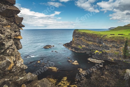 Preview: Irish bay surrounded by the green covered hills