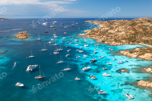 Preview: Aerial view of luxury yachts and boats moored in the crystal-clear turquoise sea
