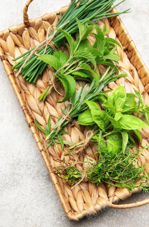 Preview: Freshly picked herbs displayed on a woven tray, a culinary delight