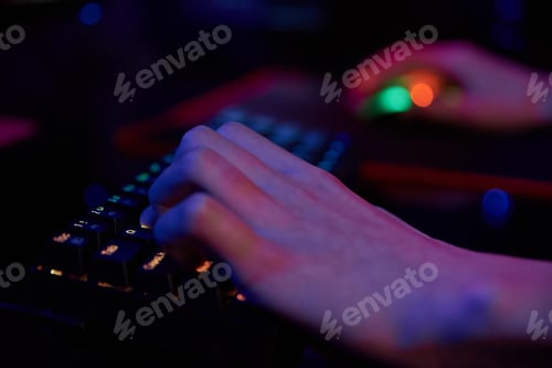 Preview: Gamer play computer game, use rgb neon colored keyboard