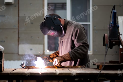 Preview: The man works with a welding machine.