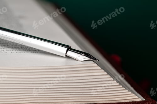 Preview: Close up of a fountain pen on a book