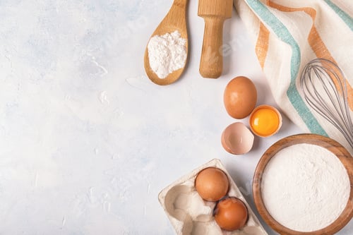 Preview: Ingredients for baking - flour, wooden spoon, eggs.