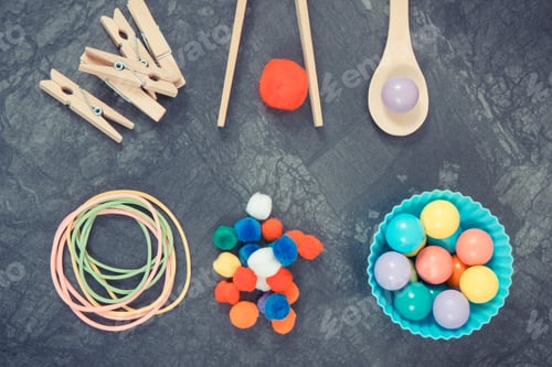 Preview: Colorful pompoms, balls and rubber erasers using for playing and development of kids motor skills