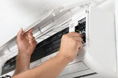 Preview: Male technician repairing air conditioner indoors