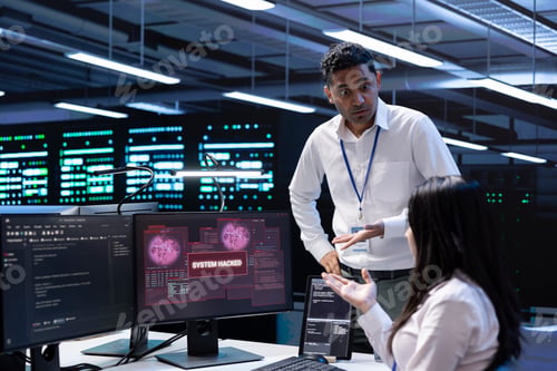 Preview: Colleagues in data center workspace trying to fix security breach