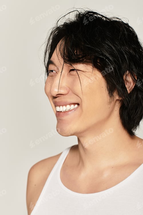 Preview: Handsome young asian man smiles stylishly while showcasing modern urban fashion trends