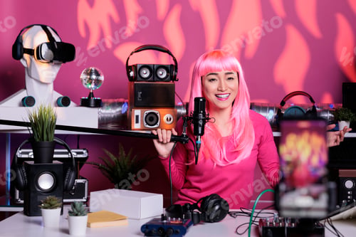Preview: Cheerful woman recording podcast using professional streaming equipment while standing in broadcast