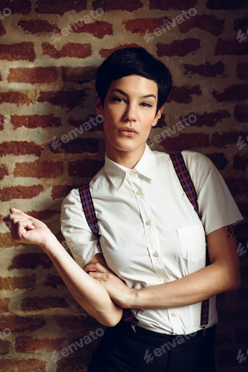 Preview: Beautiful young woman with very short haircut, looking at camera