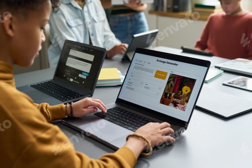 Preview: Teenage Black Boy Using Laptop Computer While Collaborating with Classmates