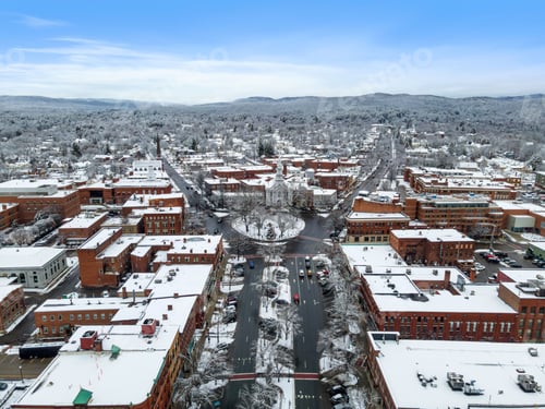 Preview: Aerial view of residential buildings and roads covered in the snow in Keene, New Hampshire