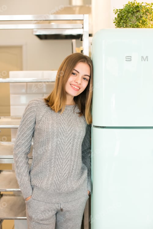 Preview: Young stylish girl in modern clothes having a french breakfast in a cafe