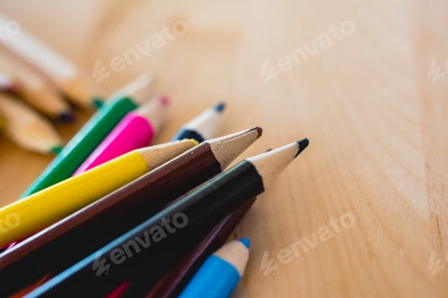 Preview: Colored pencils on a table with space for text.