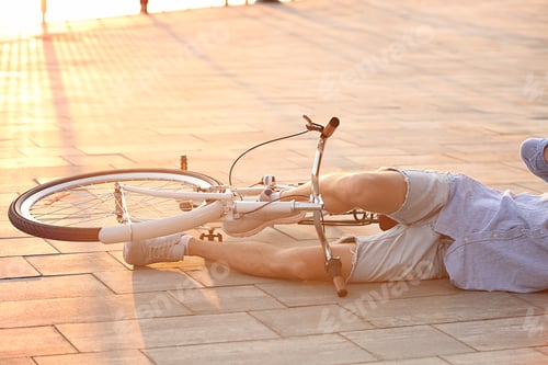 Preview: Man fallen off his bicycle on street, closeup