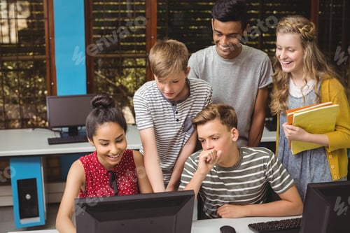 Preview: Smiling students studying in computer classroom