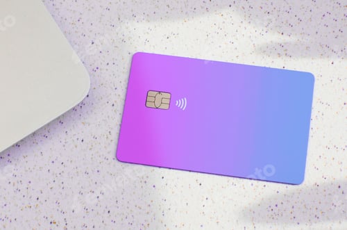 Preview: Closeup of a gradient purple and blue credit card isolated on an empty surface