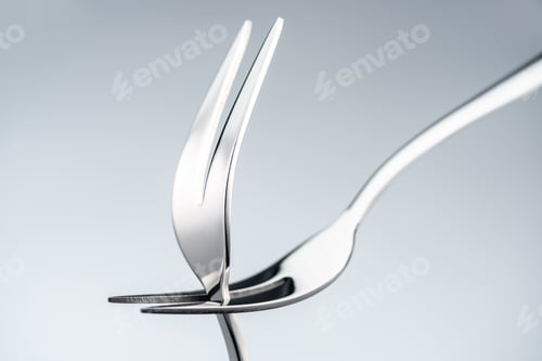 Preview: shiny forks with two tines isolated on grey